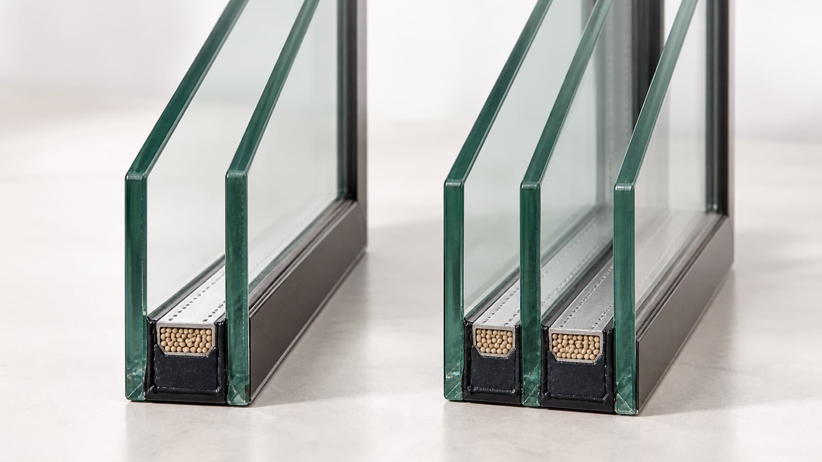 Conceptual illustration of two-pane and three-pane glazing sections.