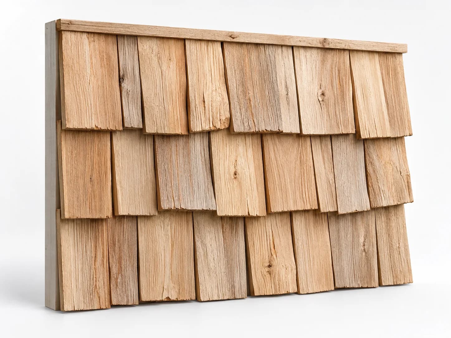 Staggered overlapping cedar siding pieces with varied widths and textured natural wood faces.