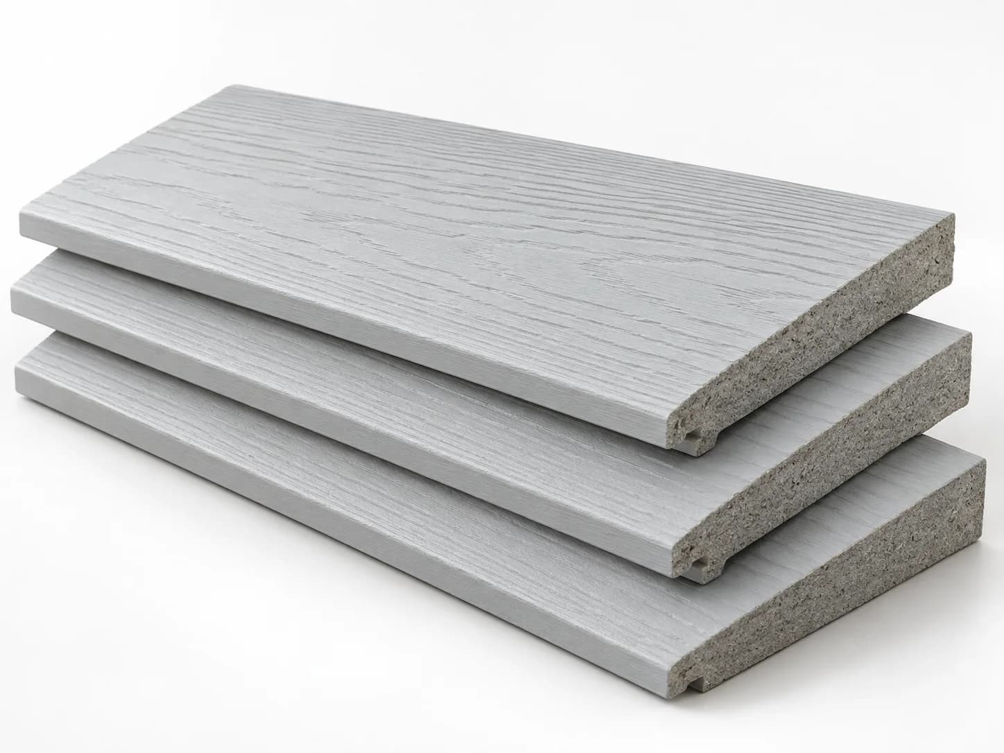 Stacked fibre-cement siding samples with painted faces and exposed dense grey cut edges.