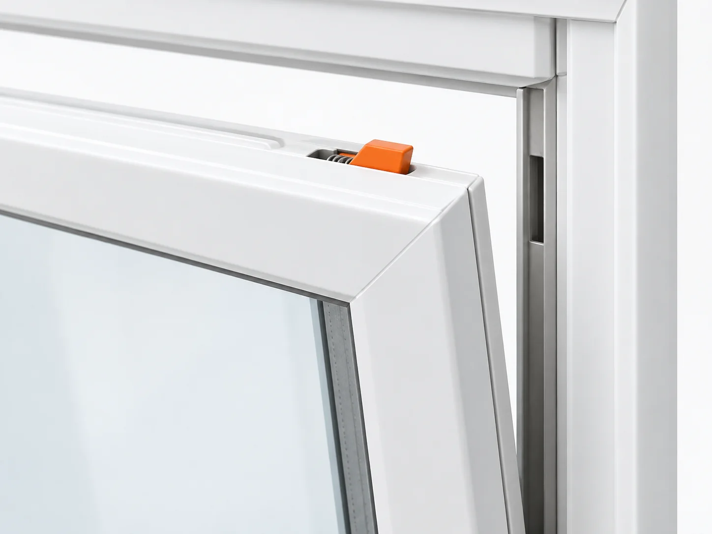 Upper sash corner with the small retractable tilt-latch tab highlighted orange.