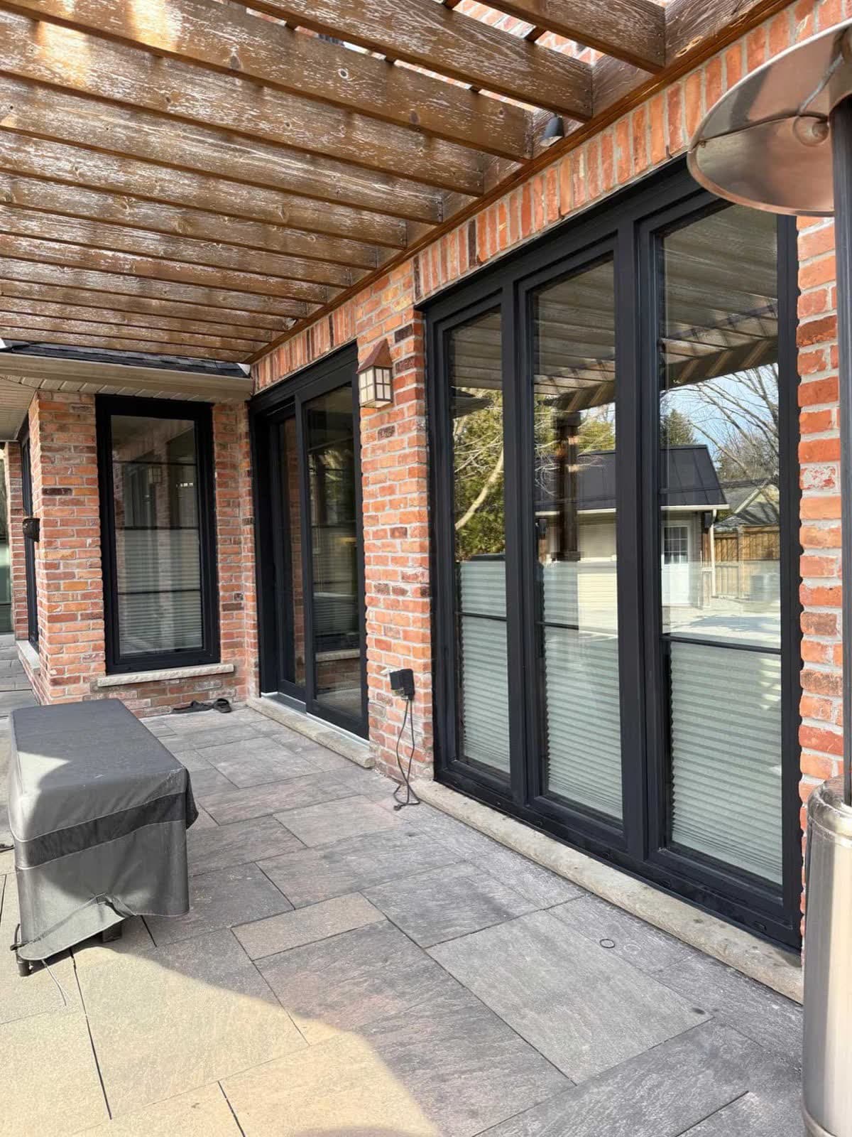 Installed sliding patio door connecting a room to the backyard.